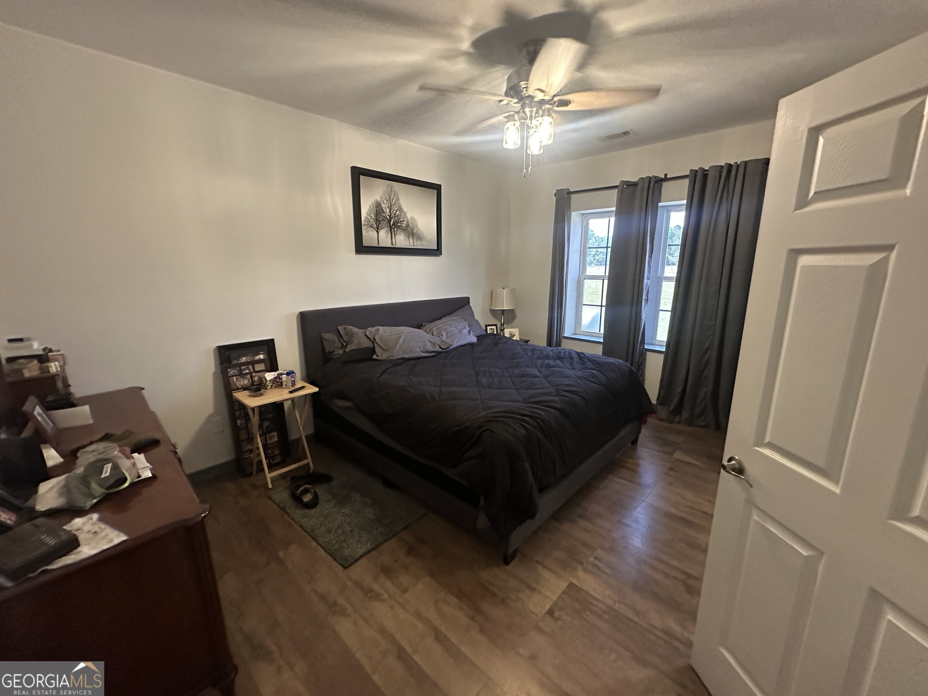 925 Cleary Road Brooklet, GA 30415 - Photo 12 of 48 a bedroom with a bed and a chandelier