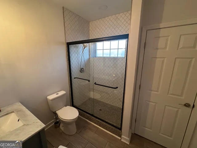 a bathroom with a toilet and a shower