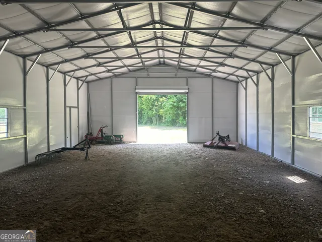 a big room with windows and ceiling fan
