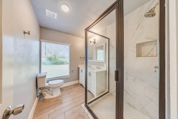 a bathroom with a toilet and a shower