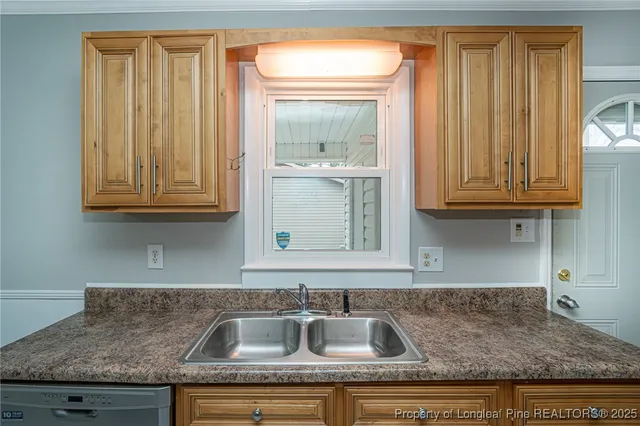 a kitchen with granite countertop a sink and cabinets