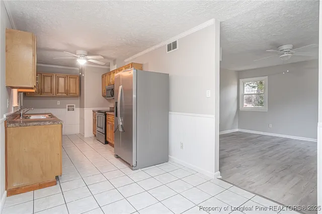 a kitchen with a refrigerator and a sink