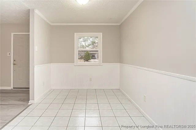 an empty room with white walls and tiles