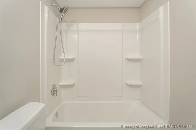 a bathroom with a shower and a toilet