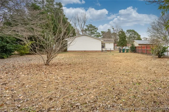 a backyard of a house with large trees