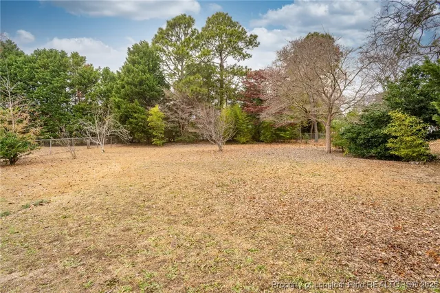 a view of white house with a yard
