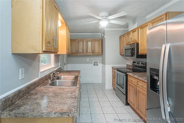 a kitchen with granite countertop a refrigerator and a sink