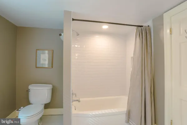 a bathroom with a shower and a toilet