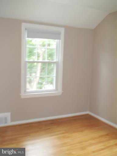 5842 Monticello Road Alexandria, VA 22303 - Photo 7 of 26 a view of an empty room with wooden floor and a window