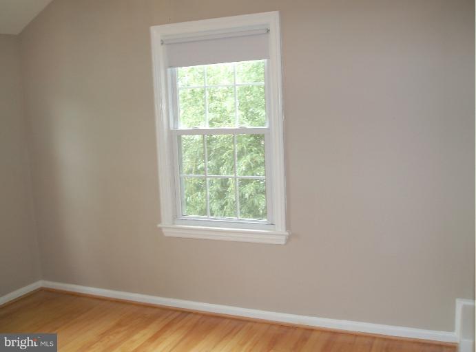 5842 Monticello Road Alexandria, VA 22303 - Photo 8 of 26 a view of a small space with wooden floor and a window