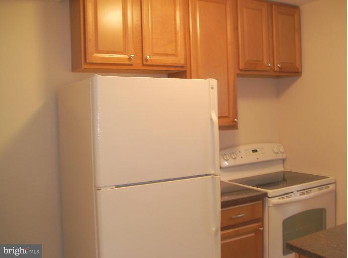 5842 Monticello Road Alexandria, VA 22303 - Photo 9 of 26 a white refrigerator freezer and a stove