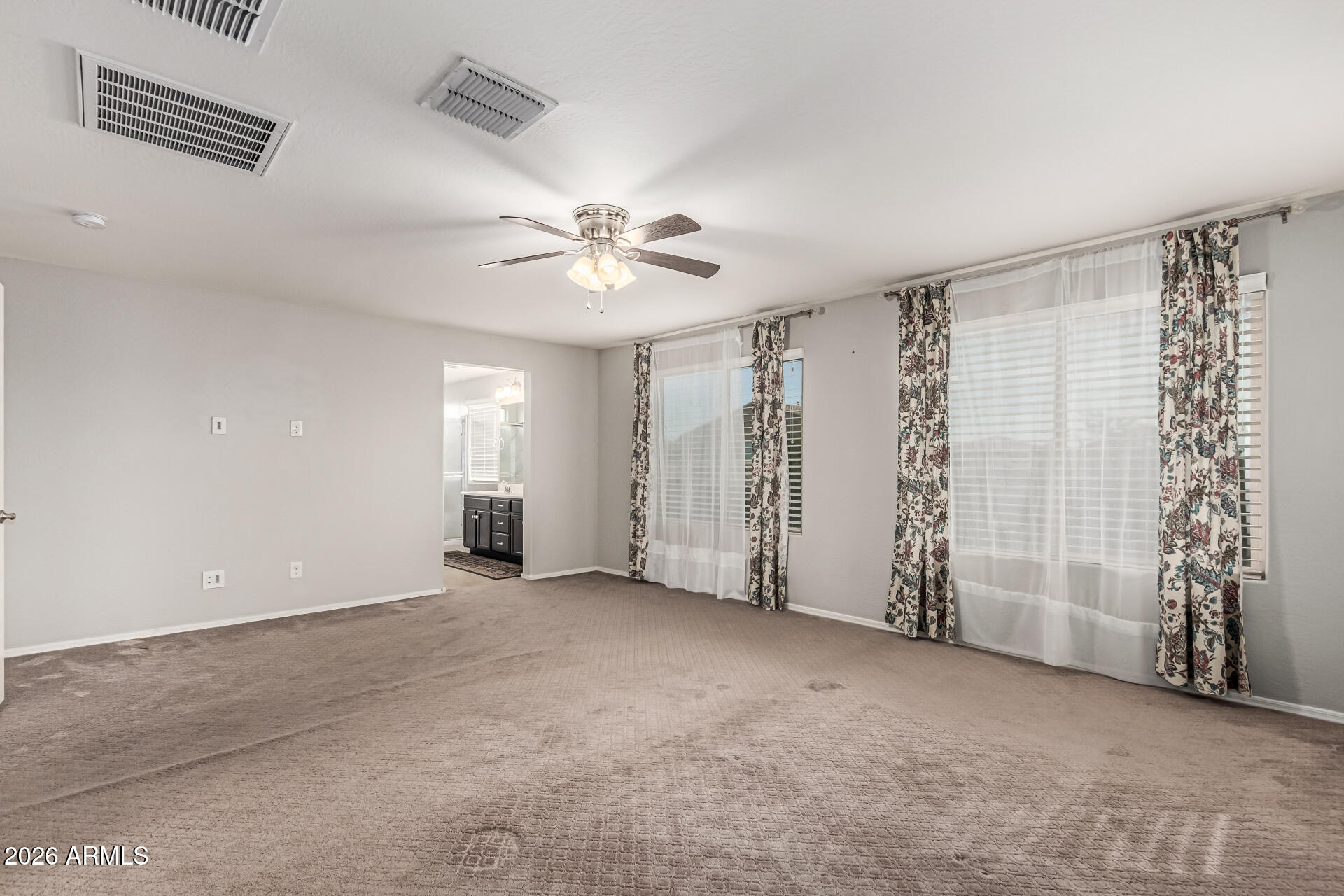 2381 East Brigadier Drive Gilbert, AZ 85298 - Photo 18 of 36 an empty room with windows and fan