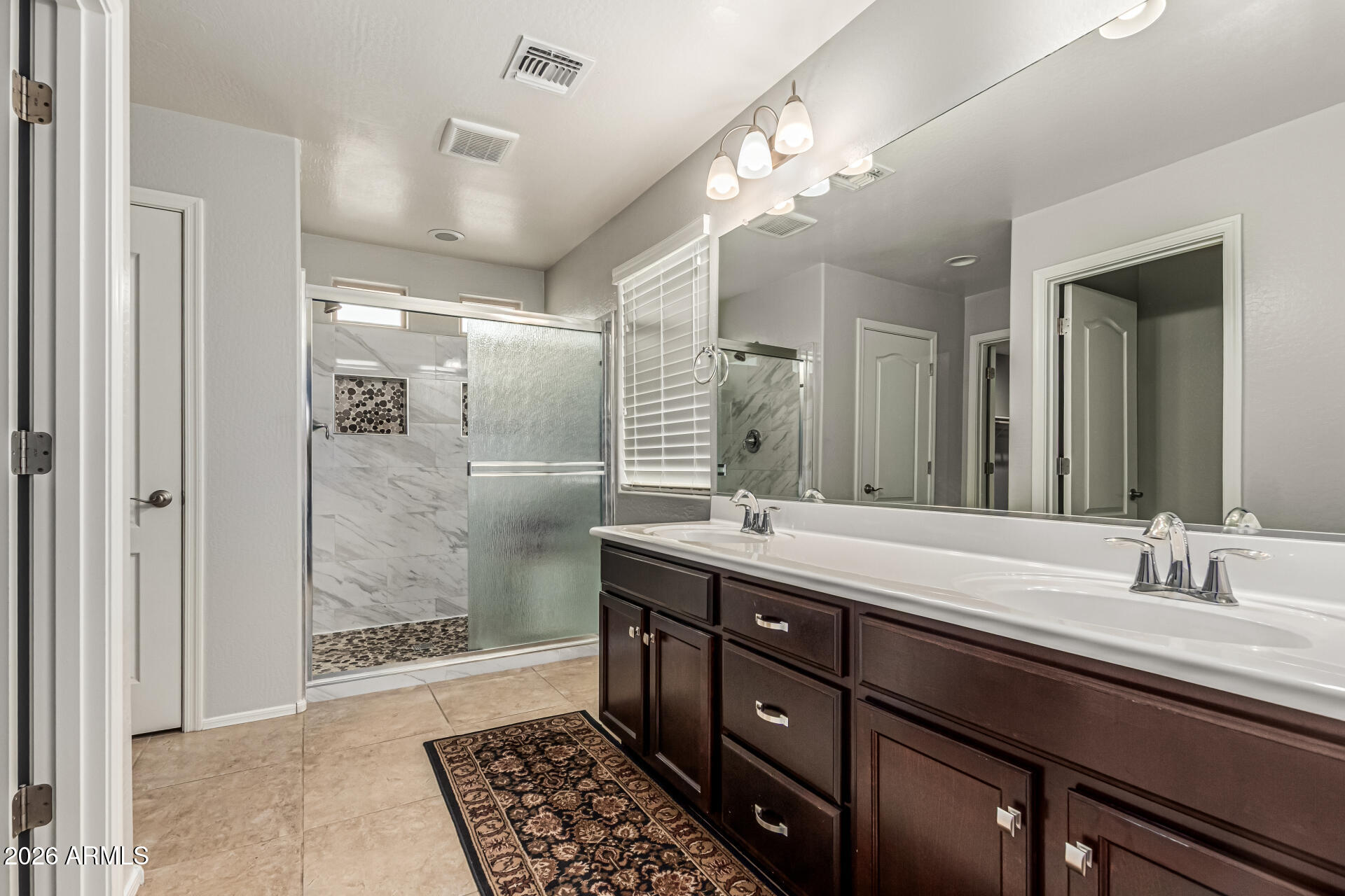 2381 East Brigadier Drive Gilbert, AZ 85298 - Photo 19 of 36 a bathroom with a double vanity sink mirror and shower