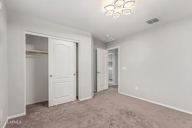 an empty room with windows and closet