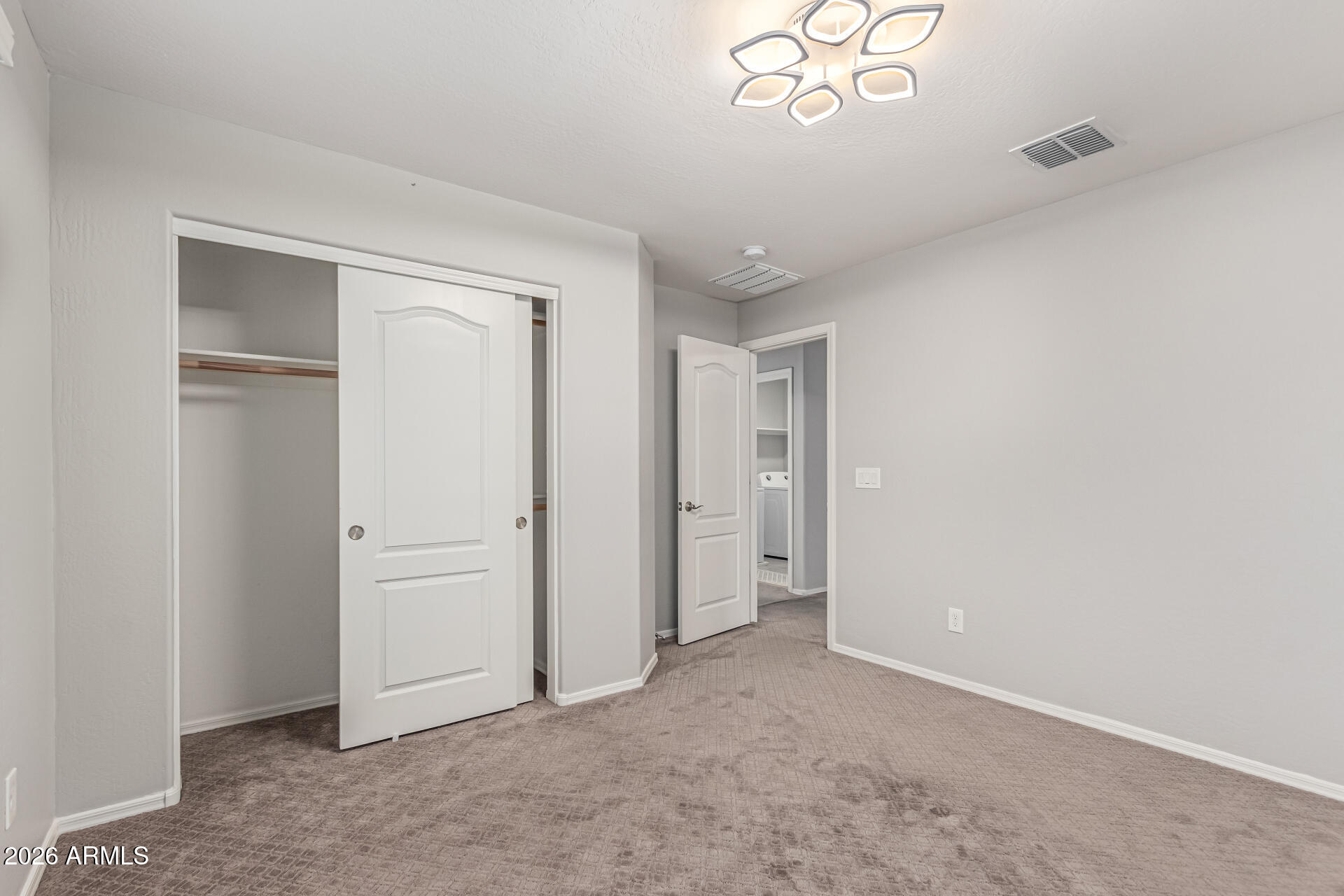 2381 East Brigadier Drive Gilbert, AZ 85298 - Photo 22 of 36 an empty room with windows and closet