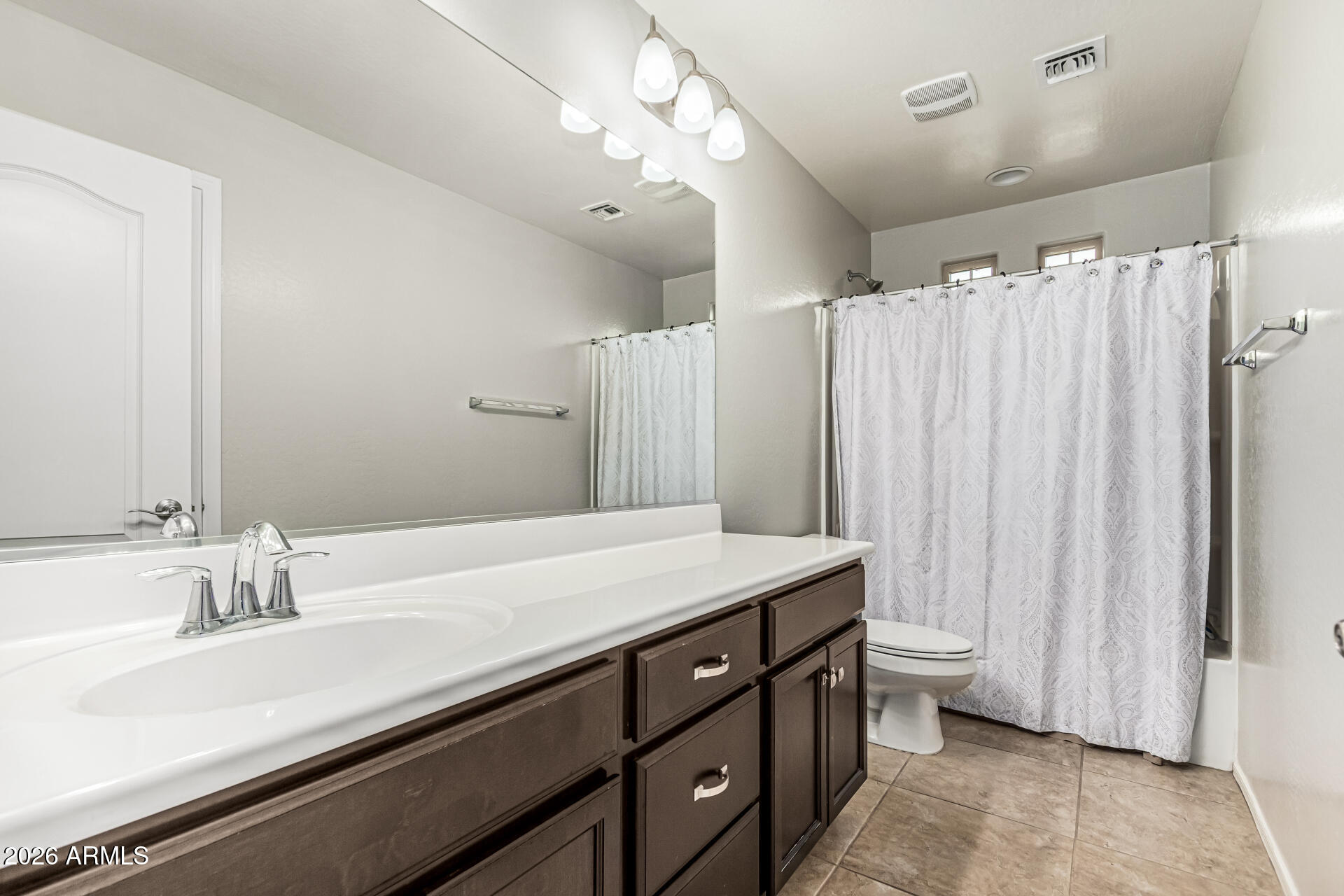 2381 East Brigadier Drive Gilbert, AZ 85298 - Photo 27 of 36 a bathroom with a double vanity sink and a mirror