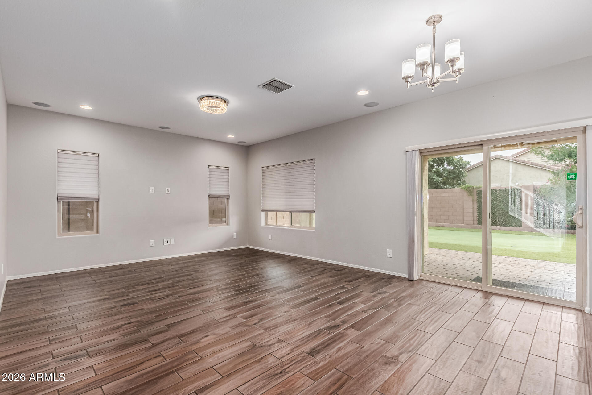 2381 East Brigadier Drive Gilbert, AZ 85298 - Photo 10 of 36 a view of an empty room with wooden floor and a window