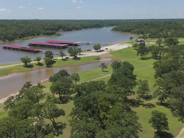 a view of a house with a yard and table and chairs
