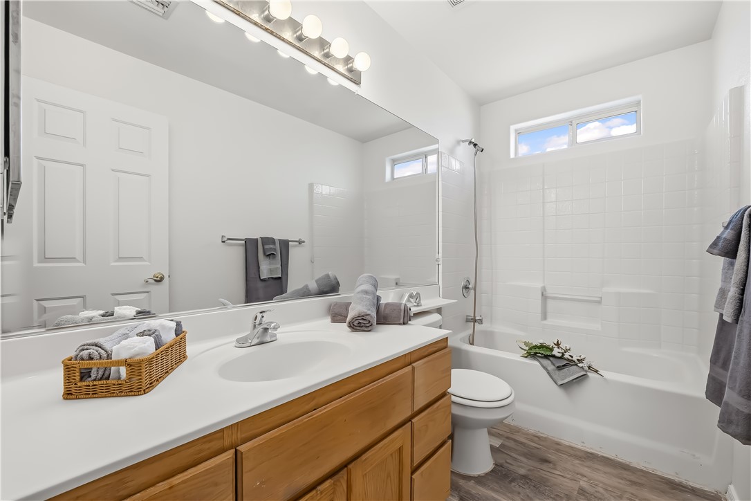 2853 Winchester Road Bullhead City, AZ 86442 - Photo 11 of 40 Bathroom featuring a wood-finish vanity with a white countertop and integrated sink