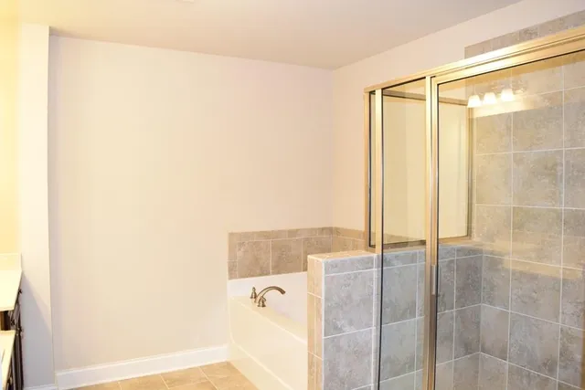 a bathroom with a shower and a mirror