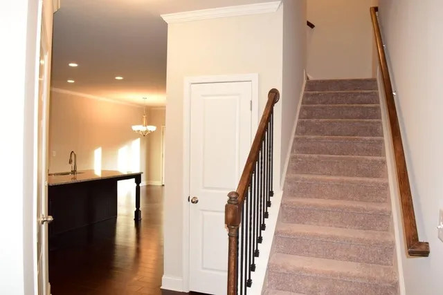 a view of entryway and hall with wooden floor