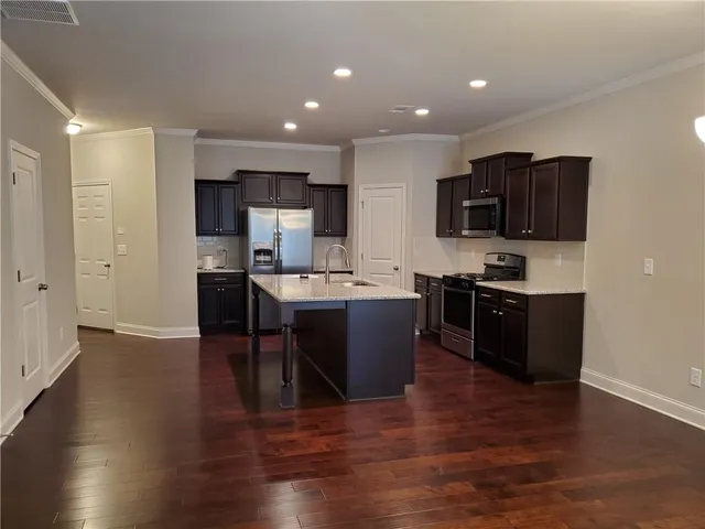 a kitchen with a sink a counter top space and appliances