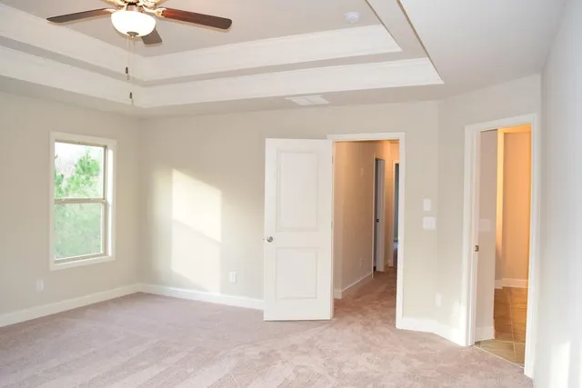 a view of a livingroom with a ceiling fan and window