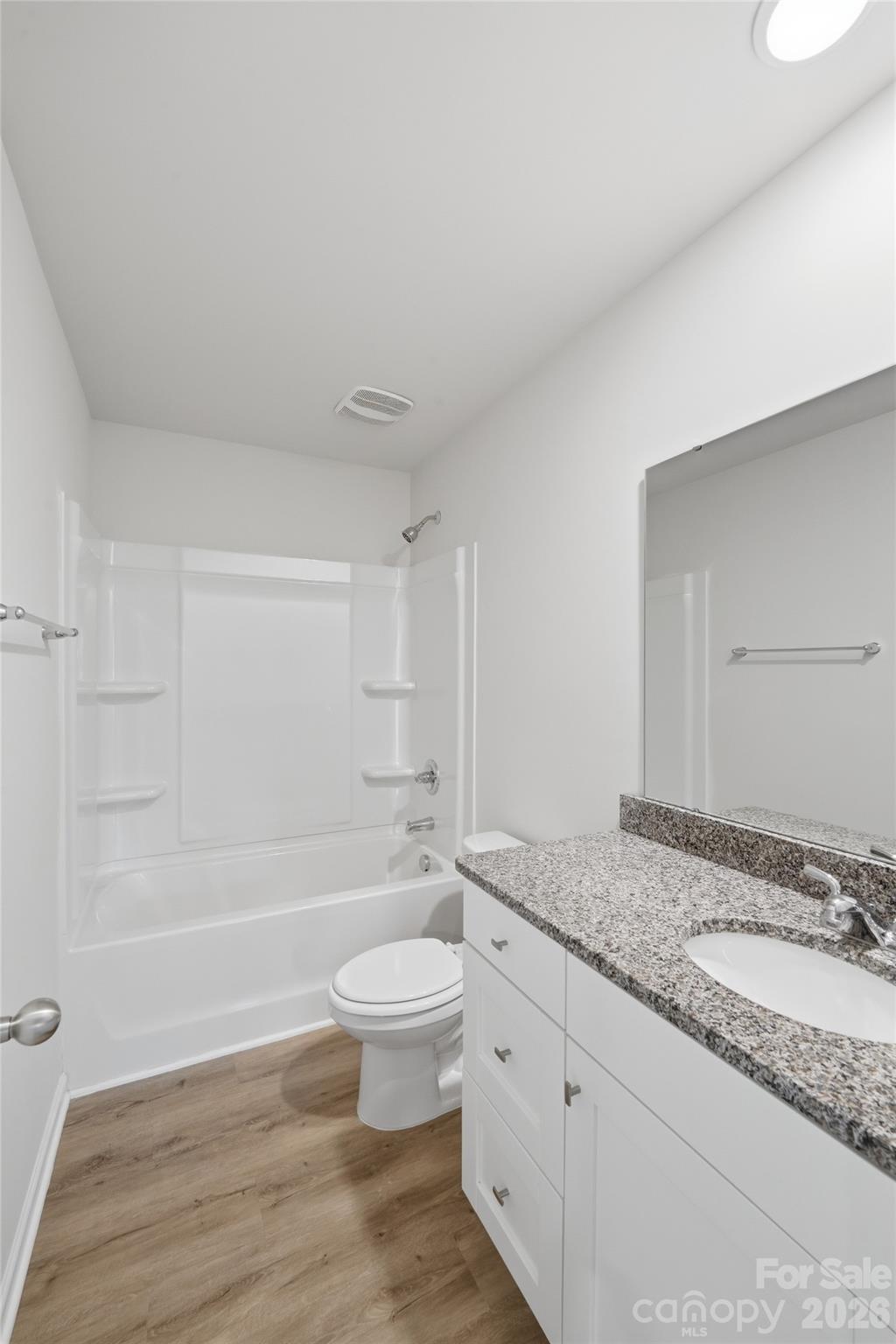 242 Landers Chapel Road Lincolnton, NC 28092 - Photo 25 of 33 a bathroom with a granite countertop sink toilet a mirror and bathtub