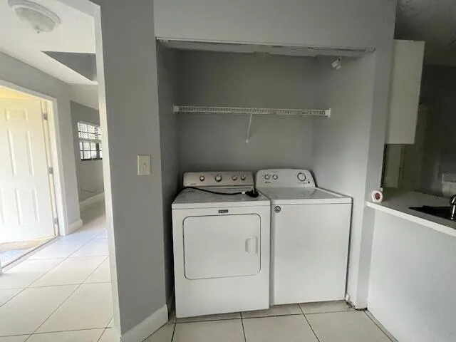 a kitchen with stainless steel appliances a refrigerator a sink a stove a microwave and cabinets