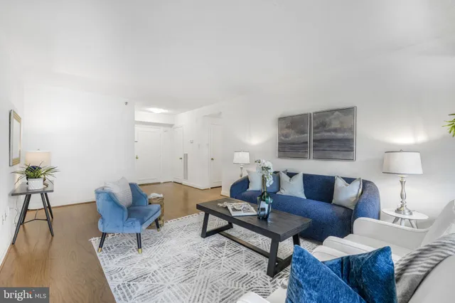 a living room with furniture and a lamp