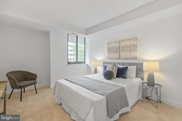 a bedroom with a bed and a chair