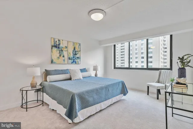 a bedroom with a large bed and a window