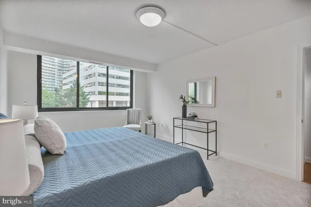 a bedroom with a bed and a table
