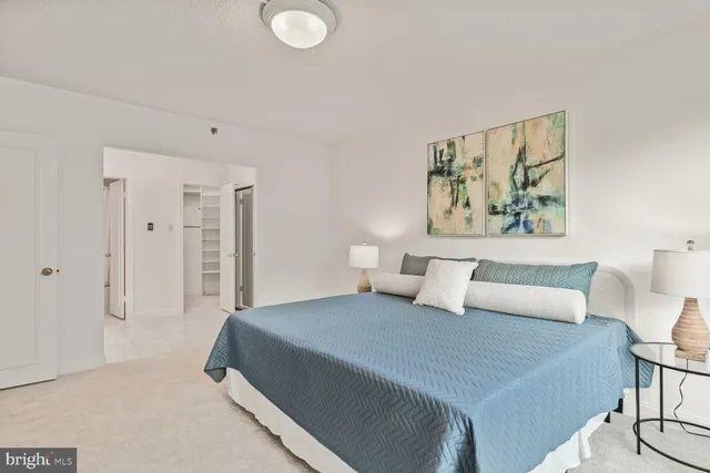 a bedroom with a bed and a painting on the wall