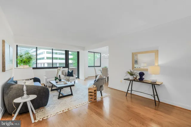 a living room with furniture and a wooden floor