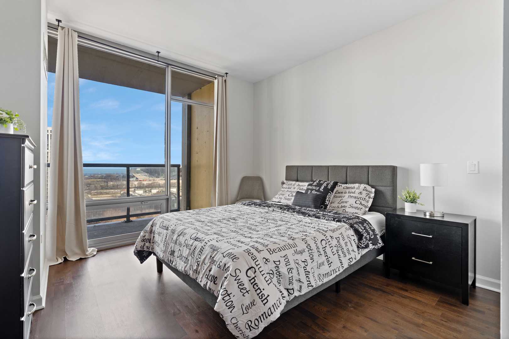 100 East 14th Street, Unit 1203 Chicago, IL 60605 - Photo 15 of 28 a bedroom with a bed and a window