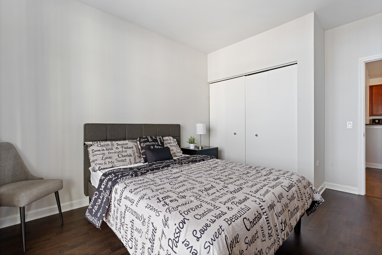 100 East 14th Street, Unit 1203 Chicago, IL 60605 - Photo 16 of 28 a bedroom with a bed and a couch