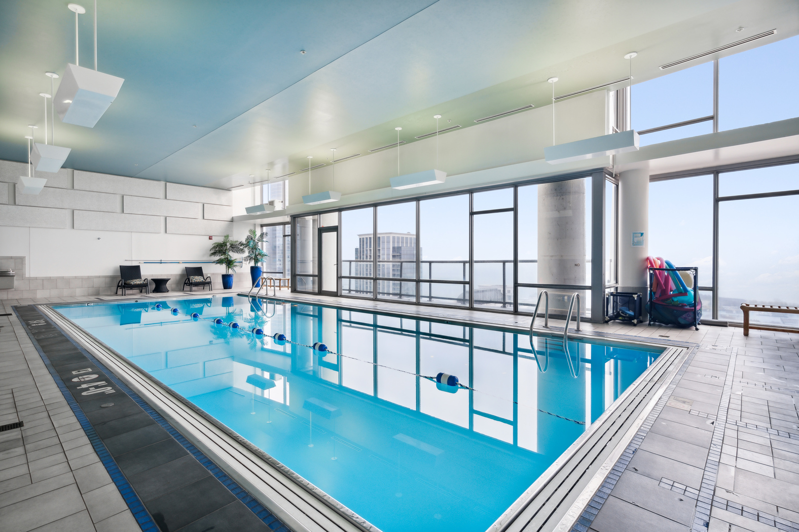 100 East 14th Street, Unit 1203 Chicago, IL 60605 - Photo 27 of 28 a large kitchen with kitchen island a large window a sink and counter space