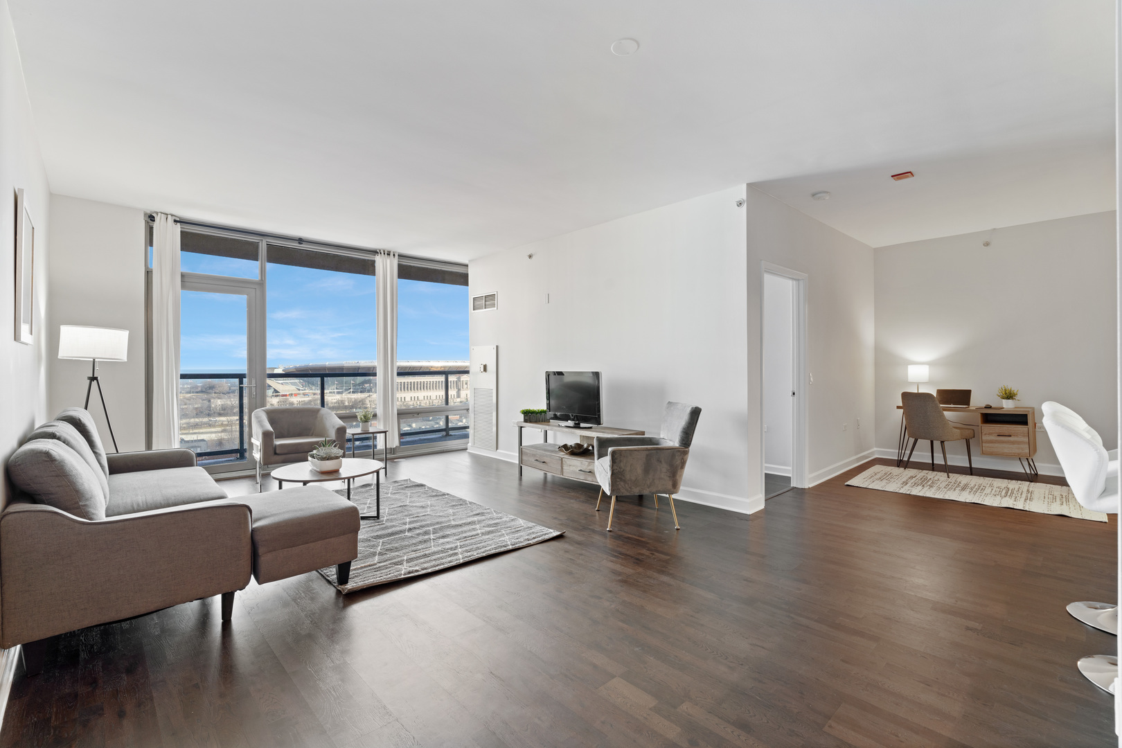 100 East 14th Street, Unit 1203 Chicago, IL 60605 - Photo 5 of 28 a living room with furniture and a wooden floor