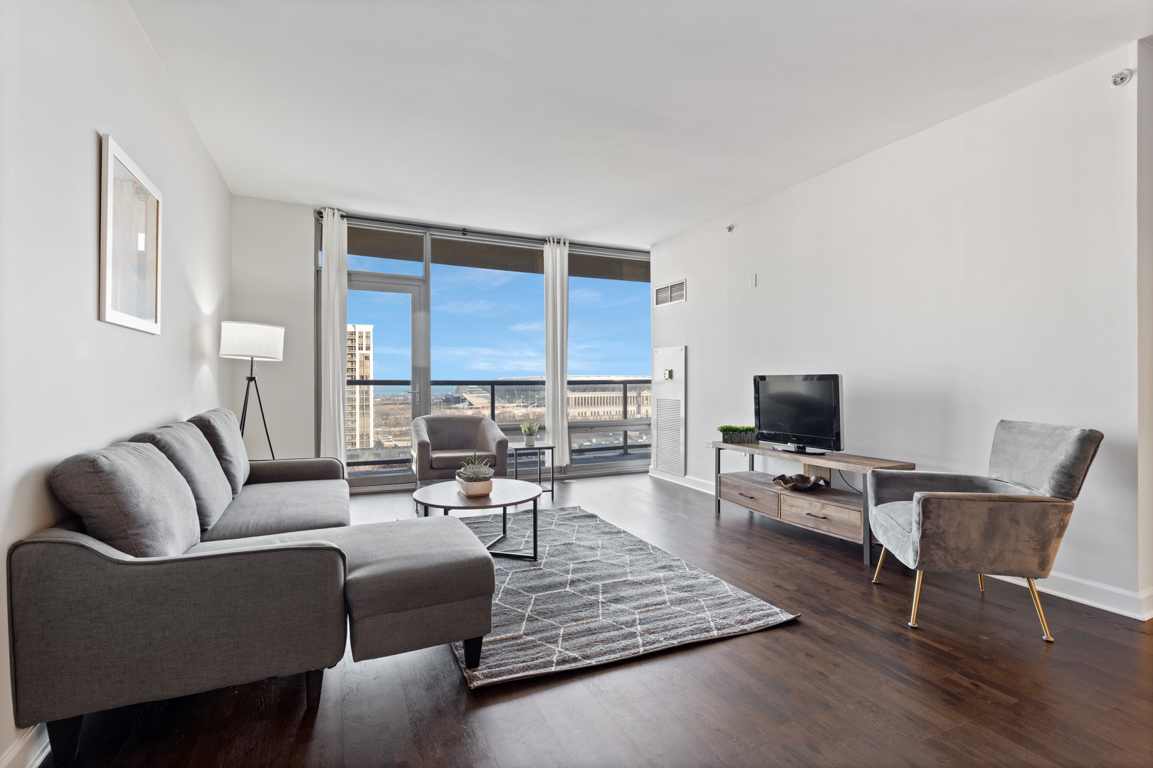 100 East 14th Street, Unit 1203 Chicago, IL 60605 - Photo 6 of 28 a living room with furniture and a flat screen tv