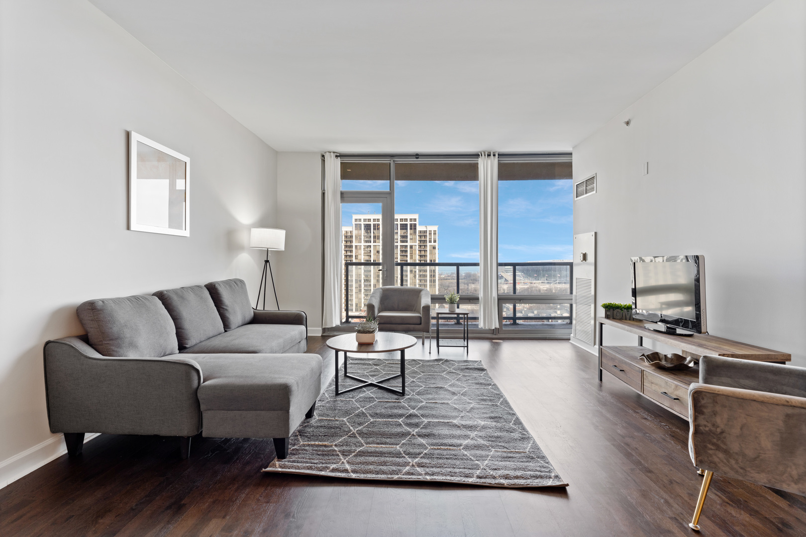 100 East 14th Street, Unit 1203 Chicago, IL 60605 - Photo 7 of 28 a living room with furniture and a wooden floor