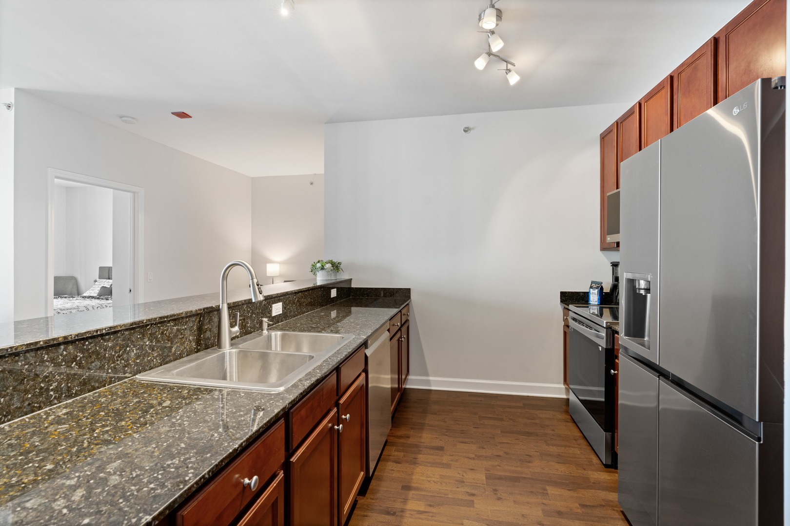 100 East 14th Street, Unit 1203 Chicago, IL 60605 - Photo 10 of 28 a kitchen with stainless steel appliances granite countertop a sink stove and refrigerator