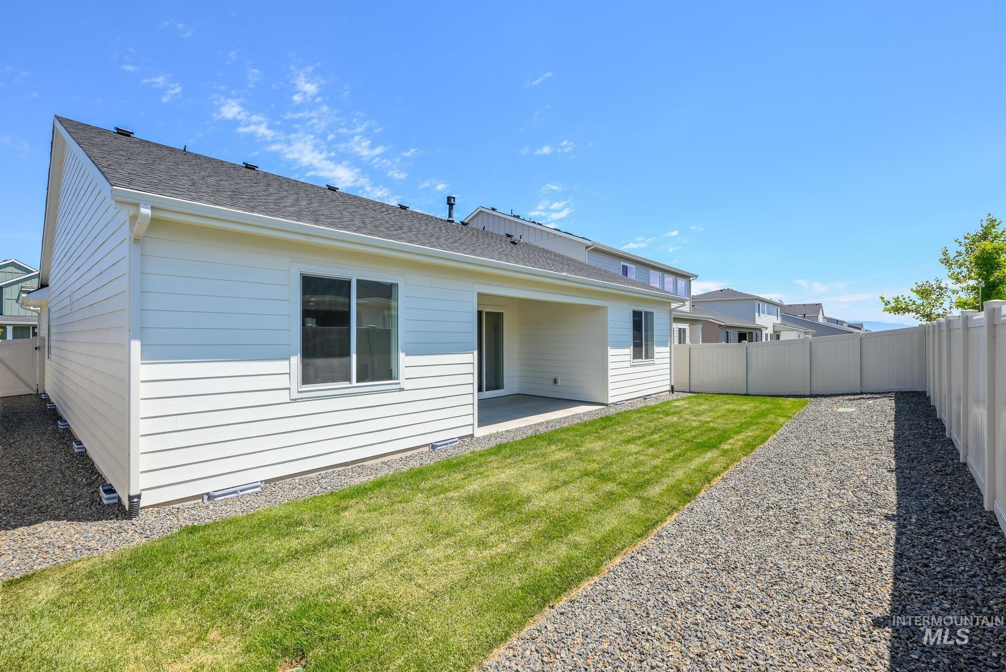 6285 West Snow Currant Street Meridian, ID 83646 - Photo 23 of 26 Rear exterior with white horizontal siding, dark shingle roof, and a covered patio