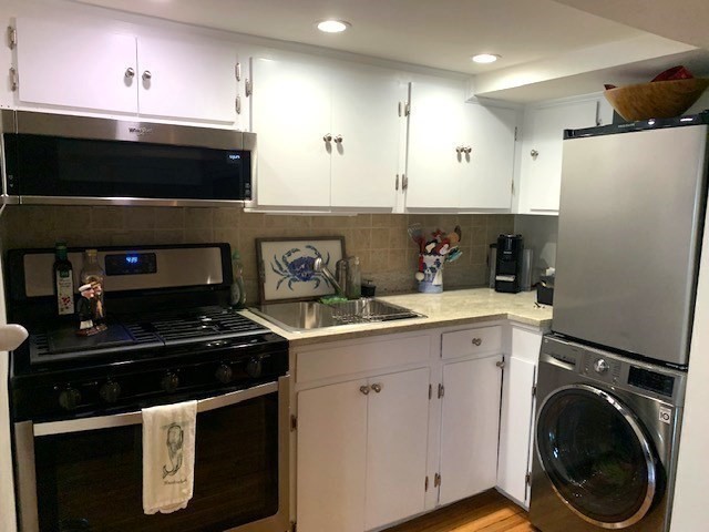7 Lee Street, Unit 1 Marblehead, MA 01945 - Photo 13 of 32 a kitchen with a sink and stainless steel appliances