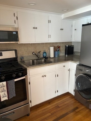 7 Lee Street, Unit 1 Marblehead, MA 01945 - Photo 14 of 32 a kitchen with granite countertop white cabinets and white appliances