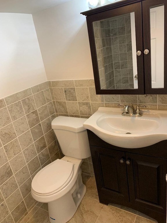 7 Lee Street, Unit 1 Marblehead, MA 01945 - Photo 20 of 32 a bathroom with a sink toilet and a mirror