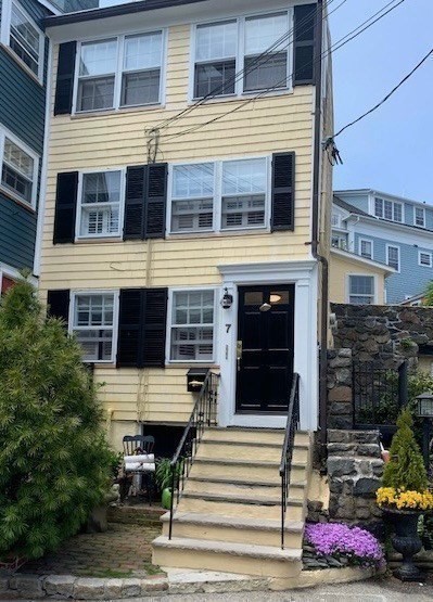 7 Lee Street, Unit 1 Marblehead, MA 01945 - Photo 2 of 32 a front view of a house with a yard