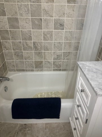 7 Lee Street, Unit 1 Marblehead, MA 01945 - Photo 21 of 32 a bathroom with a bathtub and a shower