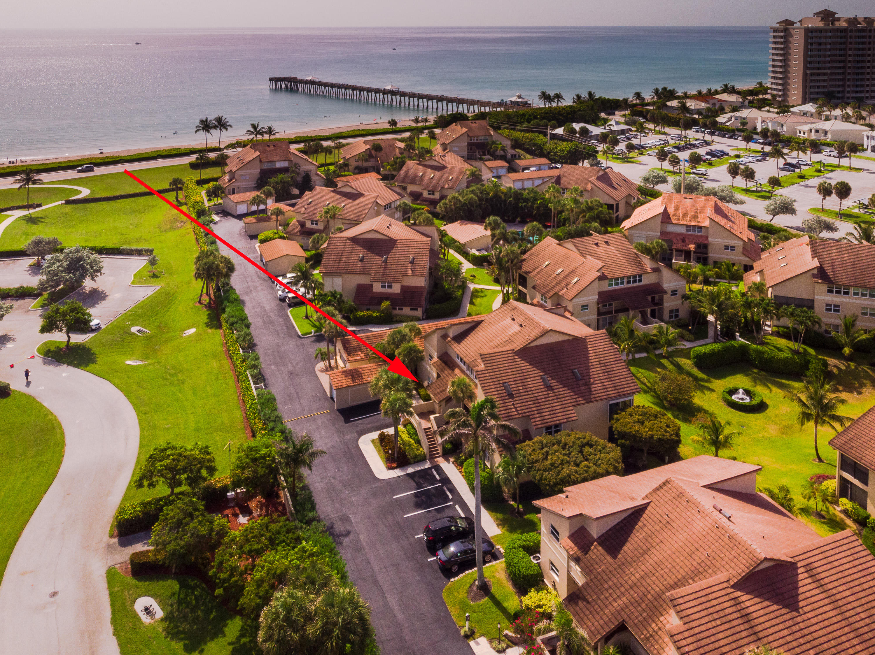 4161 U.S. Highway 1, Unit E2 Jupiter, FL 33477 - Photo 1 of 37 an aerial view of a house with a swimming pool yard and outdoor seating