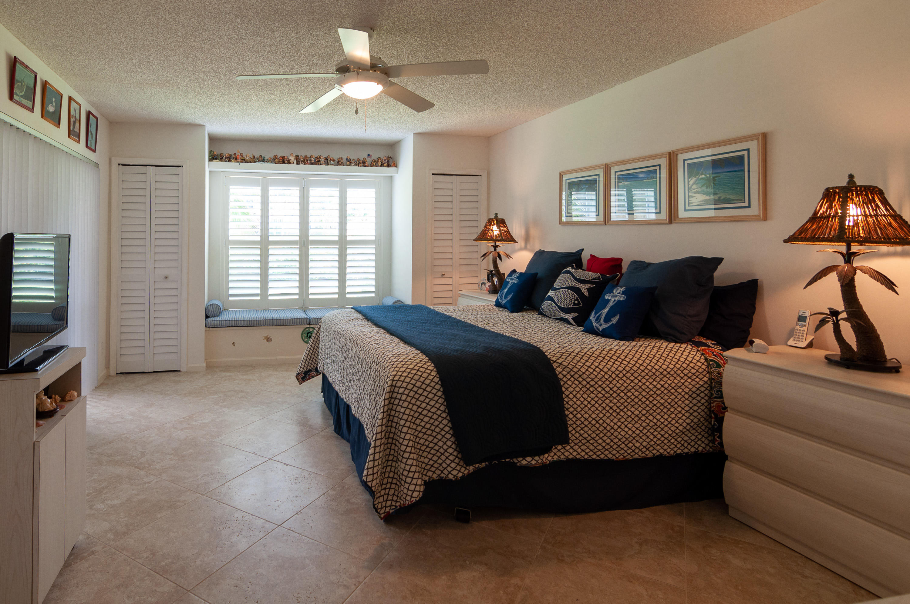 4161 U.S. Highway 1, Unit E2 Jupiter, FL 33477 - Photo 15 of 37 a spacious bedroom with a bed and a couch
